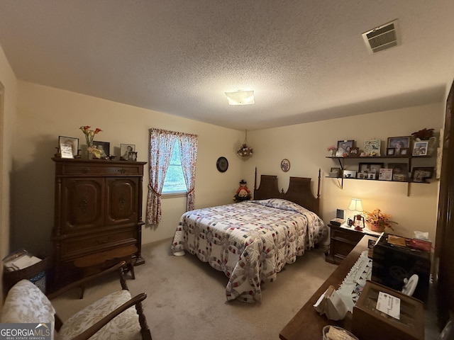 bedroom featuring carpet and a textured ceiling