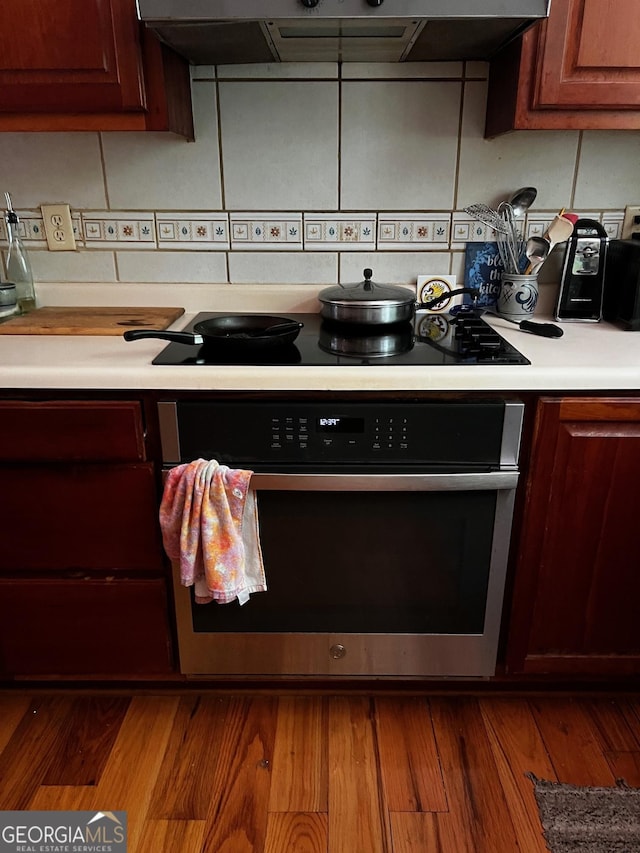 105 Chinquapin Ln, Clarkesville, GA 30523 - kitchen featuring oven, light countertops, exhaust hood, black electric stovetop, and wood finished floors