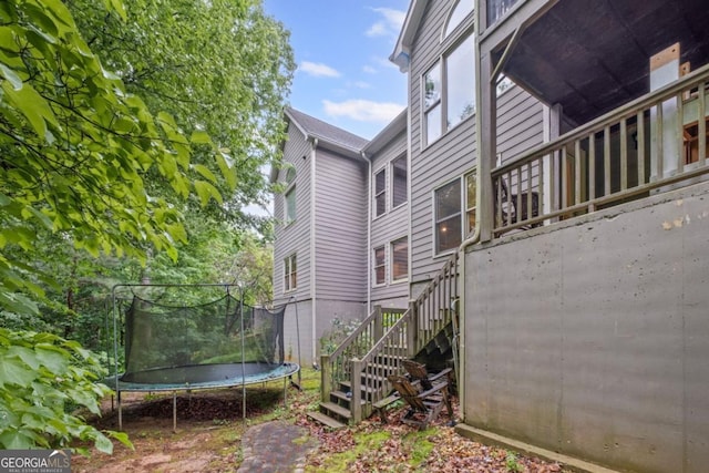 4842 Registry Dr NW, Kennesaw, GA 30152 - view of side of home with stairs and a trampoline