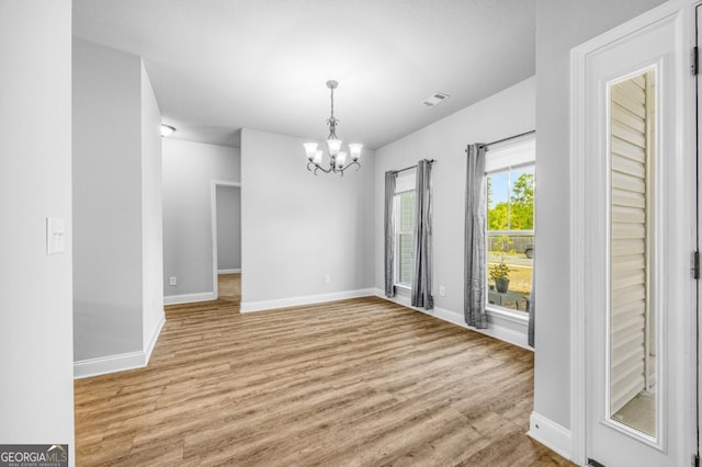 145 Gavin Way, Rincon, GA 31326 - unfurnished dining area featuring a chandelier, baseboards, and light wood finished floors