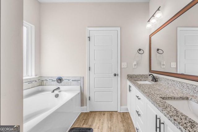 145 Gavin Way, Rincon, GA 31326 - bathroom with wood finished floors, a bath, healthy amount of natural light, and double vanity