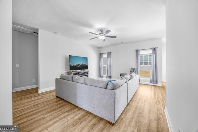 145 Gavin Way, Rincon, GA 31326 - living room featuring light wood-style flooring, ceiling fan, and baseboards