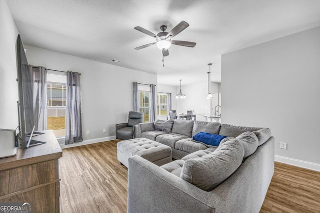 145 Gavin Way, Rincon, GA 31326 - living area with a ceiling fan, baseboards, wood finished floors, and plenty of natural light