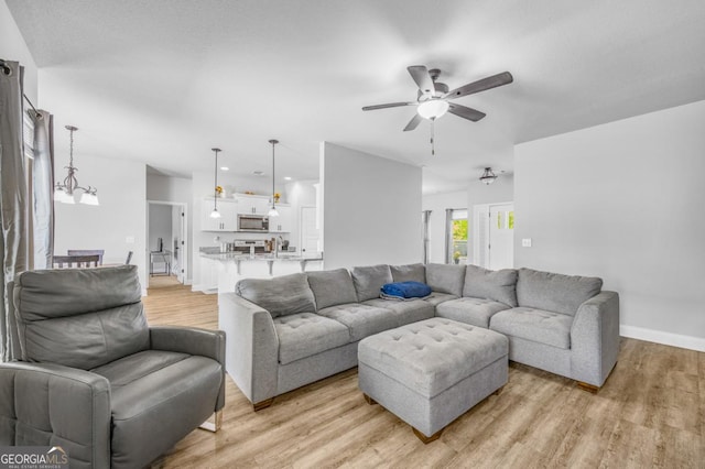 145 Gavin Way, Rincon, GA 31326 - living area featuring a ceiling fan, light wood-style floors, and baseboards