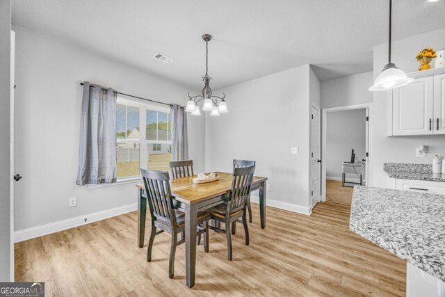 145 Gavin Way, Rincon, GA 31326 - dining space featuring a chandelier, light wood finished floors, and baseboards