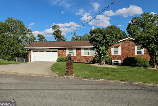 view of front of home with concrete driveway, a garage, brick siding, and a front yard