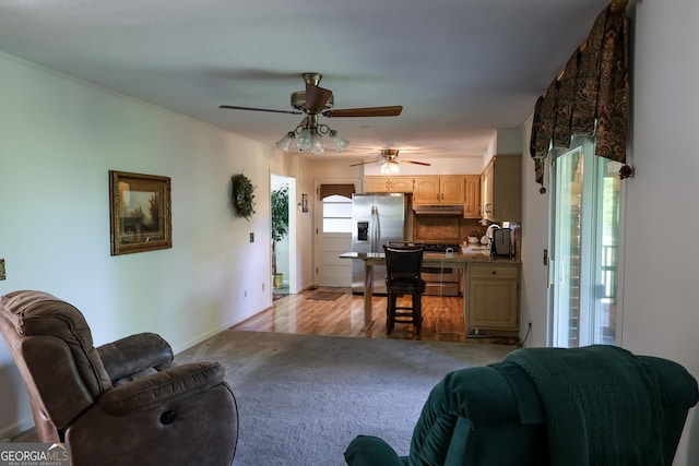 living area featuring a ceiling fan and light carpet