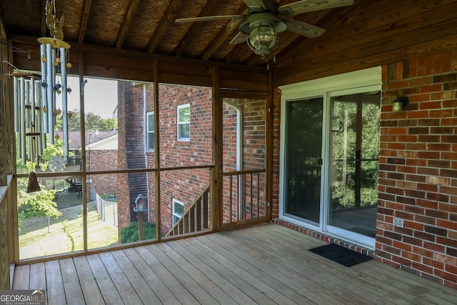 unfurnished sunroom with ceiling fan