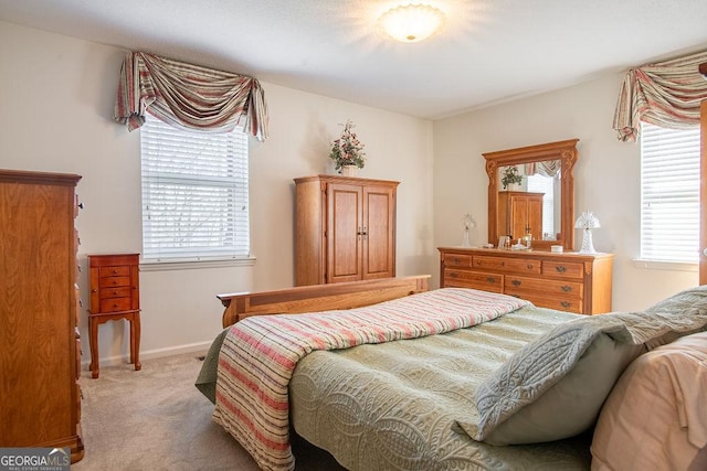 carpeted bedroom featuring baseboards