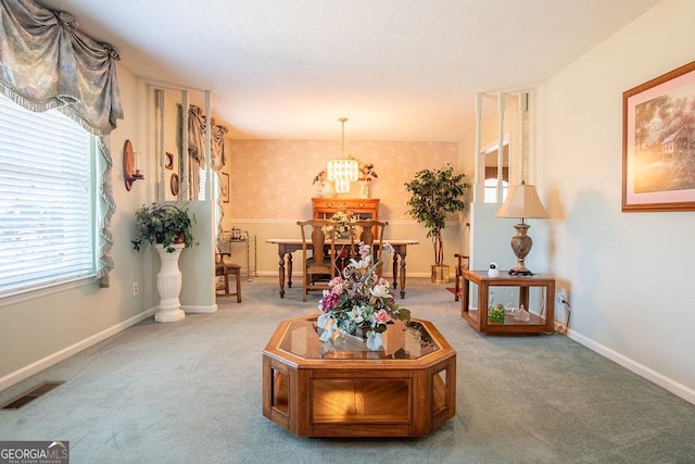 carpeted living room featuring plenty of natural light and baseboards