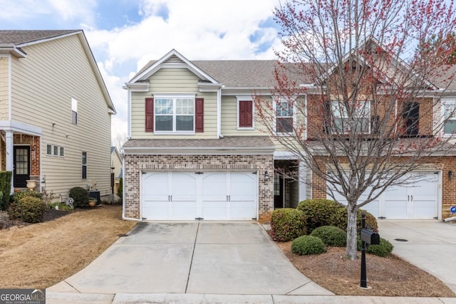 view of front of property with brick siding, driveway, and a garage