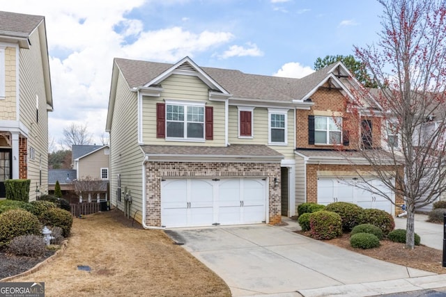 townhome / multi-family property featuring brick siding, an attached garage, concrete driveway, and a shingled roof
