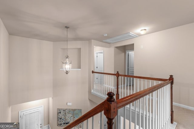 hallway featuring an upstairs landing, baseboards, carpet, and a chandelier