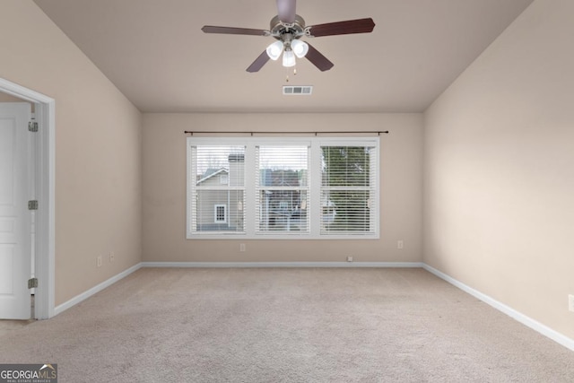 spare room with carpet, a ceiling fan, and baseboards