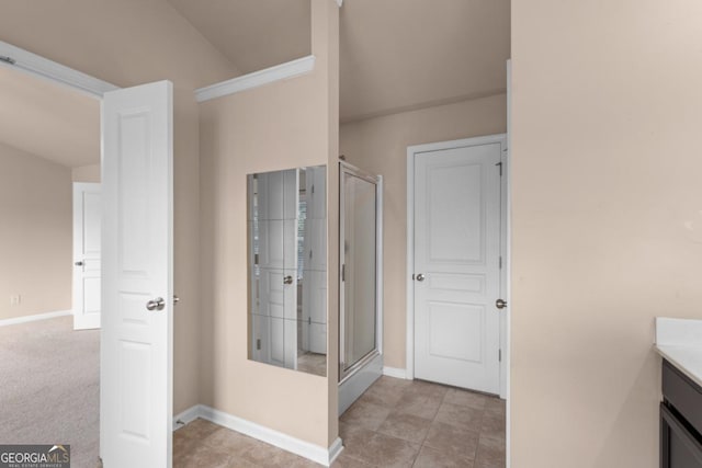 full bathroom with a shower stall, vanity, and baseboards