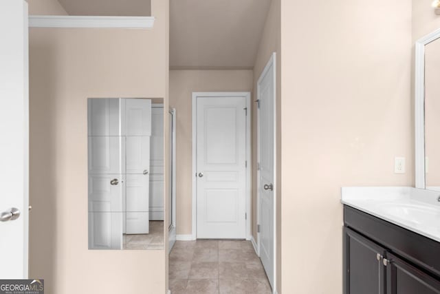 full bath featuring vanity, tile patterned flooring, and baseboards