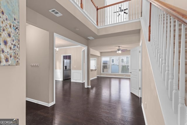 foyer featuring a ceiling fan, dark wood-style flooring, baseboards, stairway, and a high ceiling