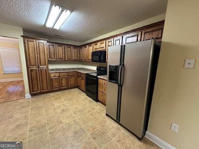 2506 Wateringhole Ct, Statesboro, GA 30458 - kitchen featuring black appliances, baseboards, and a textured ceiling