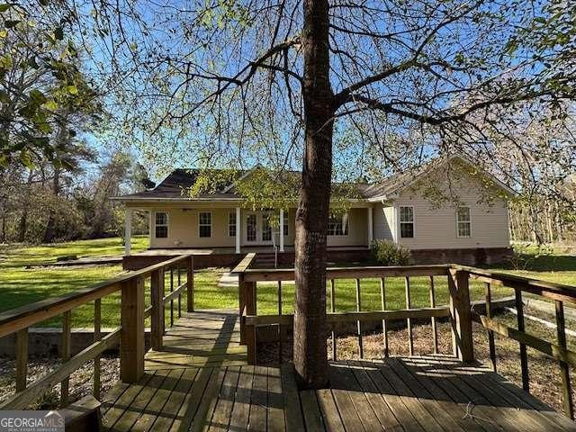 2506 Wateringhole Ct, Statesboro, GA 30458 - rear view of property featuring a deck and a lawn