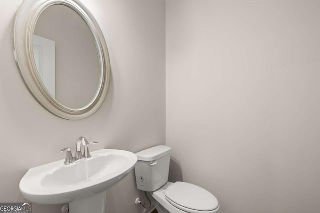 half bathroom with a sink and toilet