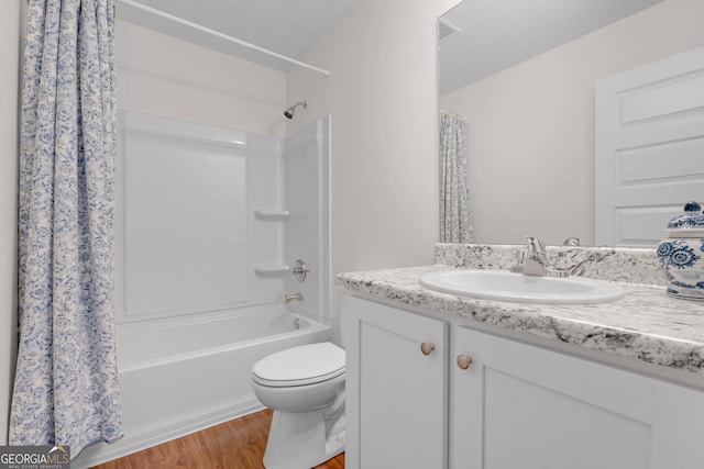 bathroom featuring wood finished floors, vanity, toilet, and shower / tub combo with curtain