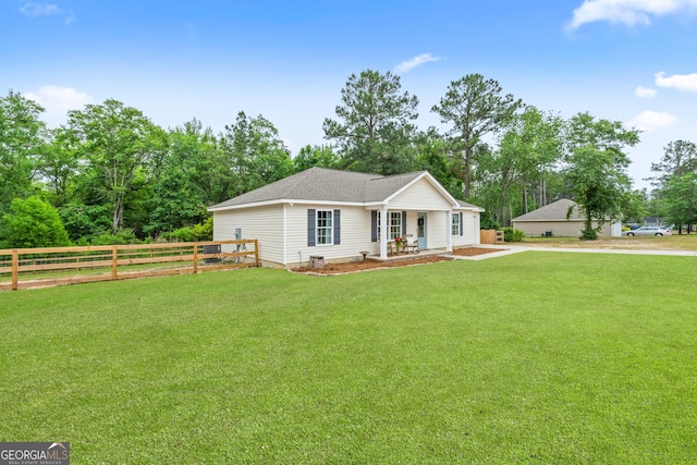 ranch-style house with covered porch and view of wooded area