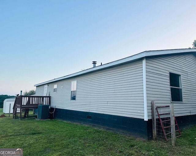 view of home's exterior with central air condition unit and a lawn