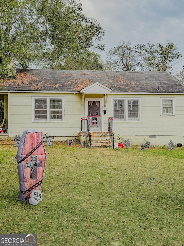 view of front of home with crawl space, a front lawn, and roof with shingles
