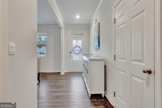 foyer featuring dark wood-style floors, crown molding, and baseboards