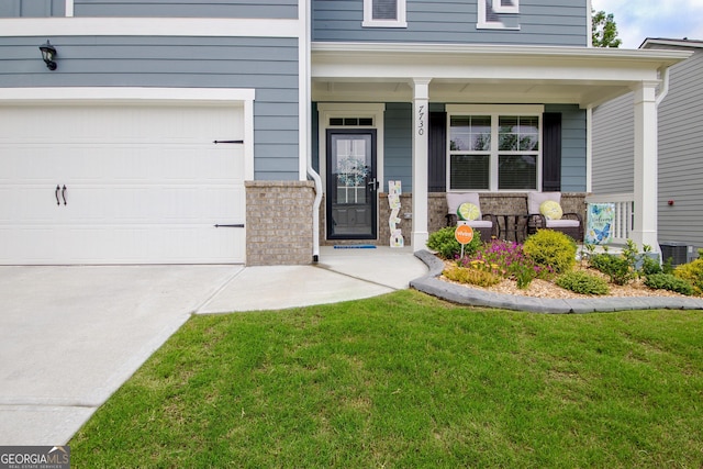 view of exterior entry featuring a porch, a lawn, cooling unit, and driveway
