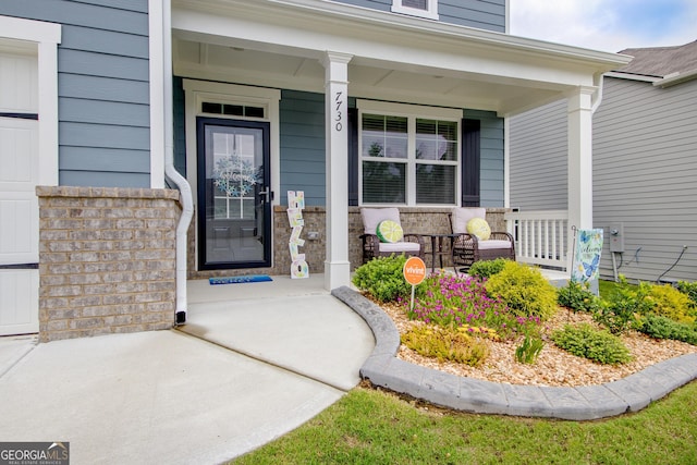 doorway to property featuring covered porch
