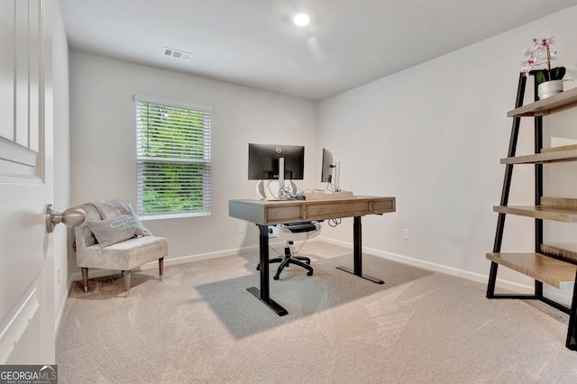 carpeted office space featuring baseboards