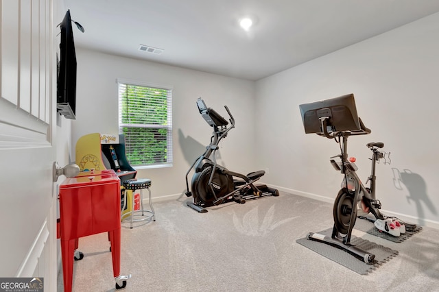 workout area featuring carpet and baseboards