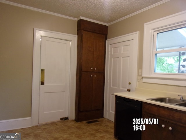 kitchen featuring dishwasher, a sink, light countertops, ornamental molding, and a textured ceiling