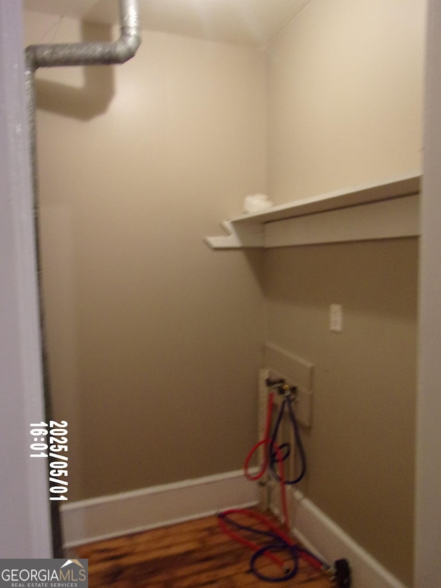laundry area featuring wood finished floors and baseboards