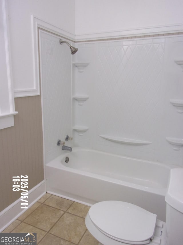 bathroom with bathtub / shower combination and toilet