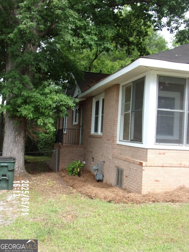 view of side of home featuring brick siding