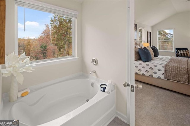 3964 Riverchess Dr SW, Atlanta, GA 30331 - bathroom featuring a garden tub, vaulted ceiling, and ensuite bath