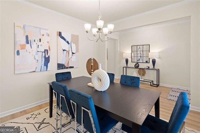 3964 Riverchess Dr SW, Atlanta, GA 30331 - dining area featuring a chandelier, baseboards, wood finished floors, and crown molding