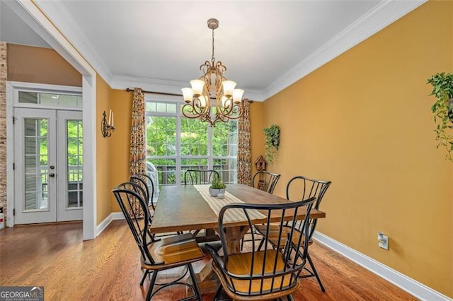 930 Brenau Point Dr, Gainesville, GA 30501 - dining room featuring wood finished floors, a chandelier, crown molding, baseboards, and french doors