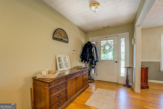 637 Lakeview Dr, Newborn, GA 30056 - foyer entrance featuring a textured ceiling, light wood-style floors, and baseboards