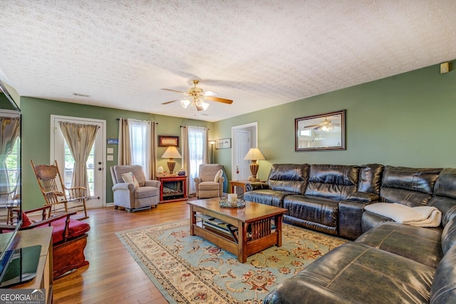 637 Lakeview Dr, Newborn, GA 30056 - living area with a textured ceiling, a ceiling fan, and wood finished floors