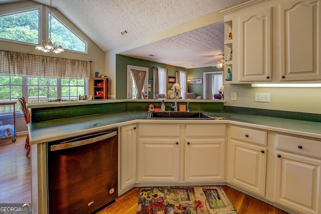 637 Lakeview Dr, Newborn, GA 30056 - kitchen featuring dishwashing machine, a sink, a textured ceiling, a chandelier, and a peninsula