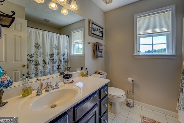 637 Lakeview Dr, Newborn, GA 30056 - bathroom featuring plenty of natural light, toilet, vanity, and tile patterned flooring
