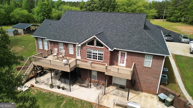 637 Lakeview Dr, Newborn, GA 30056 - rear view of house featuring brick siding, a patio area, and a wooden deck