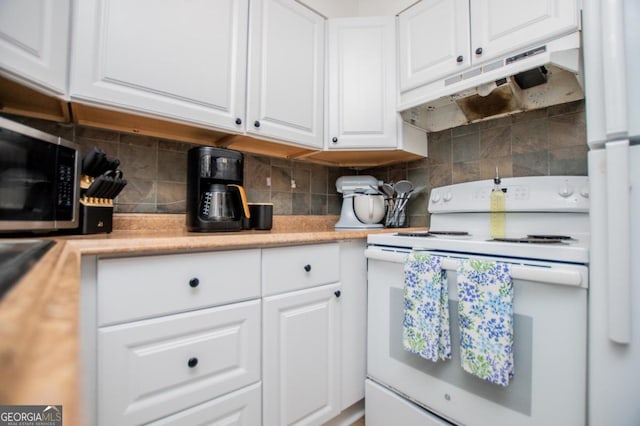 4529 Lakeview Dr, Powder Springs, GA 30127 - kitchen with electric stove, under cabinet range hood, stainless steel microwave, white cabinets, and light countertops
