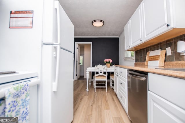 4529 Lakeview Dr, Powder Springs, GA 30127 - kitchen featuring stainless steel dishwasher, white cabinets, light wood-style flooring, tasteful backsplash, and freestanding refrigerator