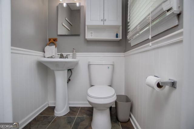 4529 Lakeview Dr, Powder Springs, GA 30127 - half bathroom featuring a wainscoted wall and tile patterned flooring