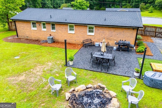 4529 Lakeview Dr, Powder Springs, GA 30127 - back of property featuring an outdoor fire pit, brick siding, roof with shingles, a patio area, and crawl space