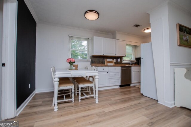 4529 Lakeview Dr, Powder Springs, GA 30127 - kitchen with dishwasher, ornamental molding, freestanding refrigerator, light wood-style flooring, and white cabinetry